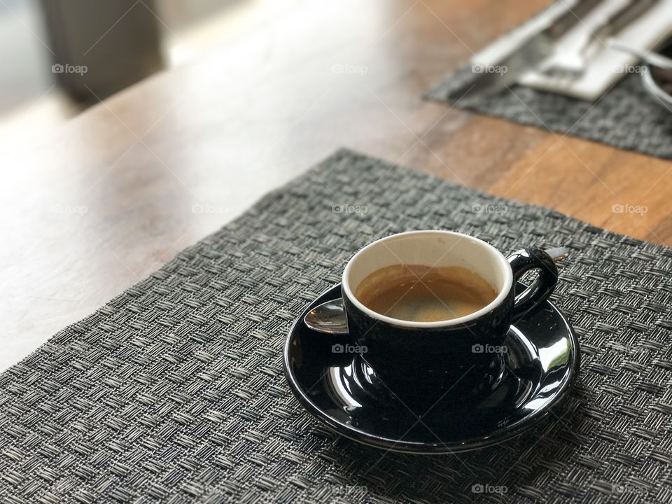Coffee cup and saucer on table