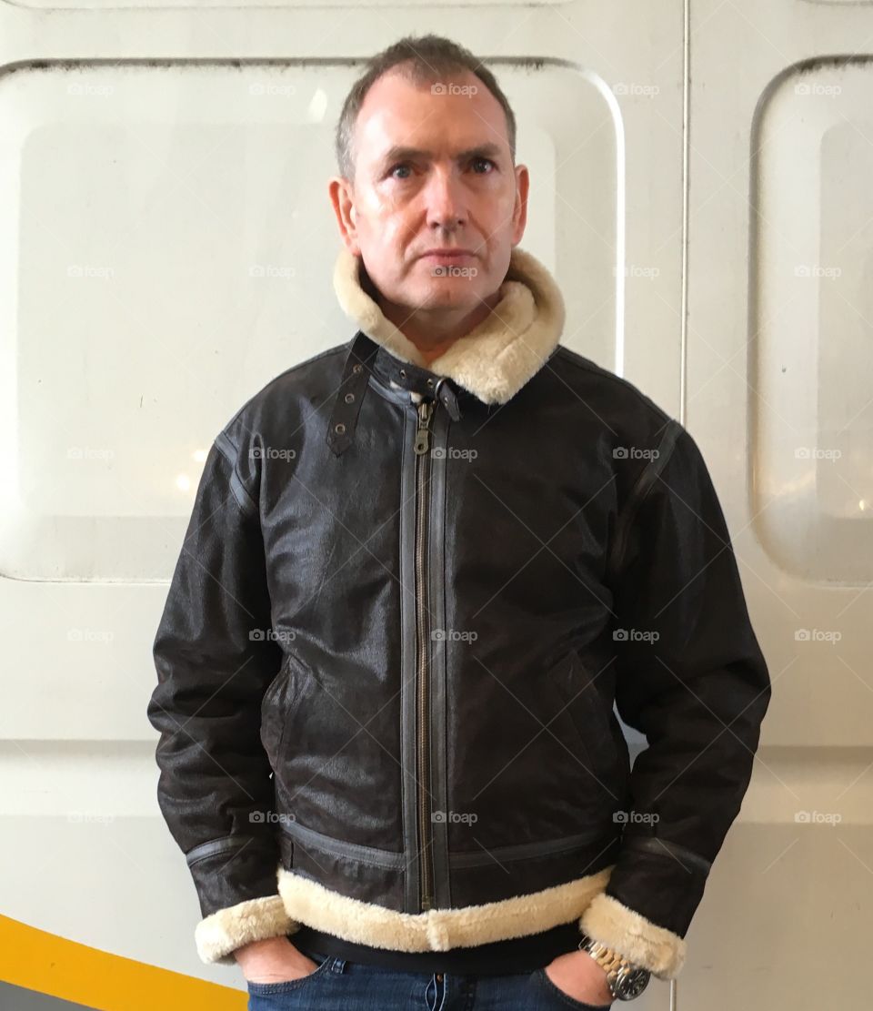 Mature man standing at home in jacket