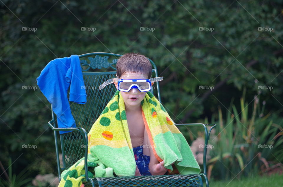 Shirting boy sitting on chair