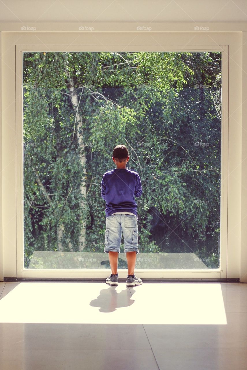 Kid looking through window