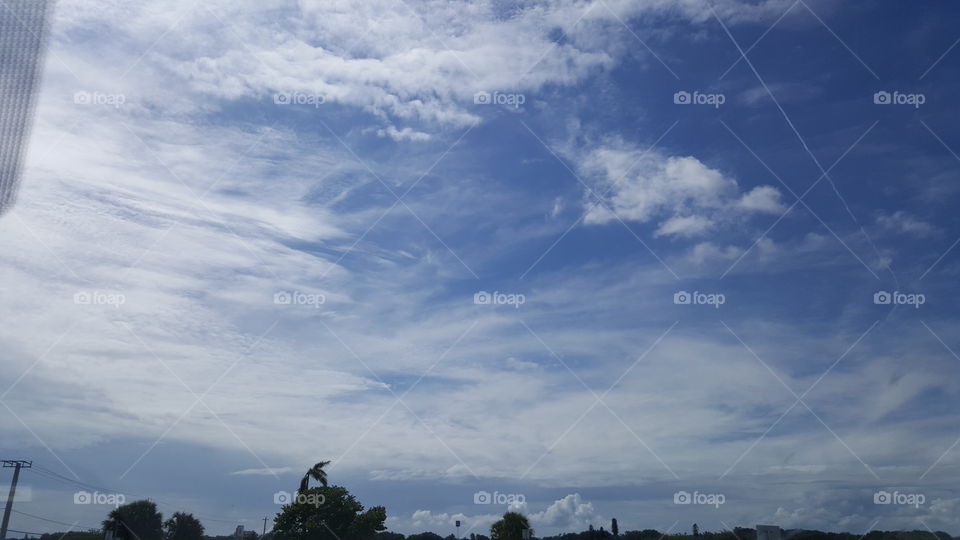 Clouds stretch across the sky on a sunny Florida day.