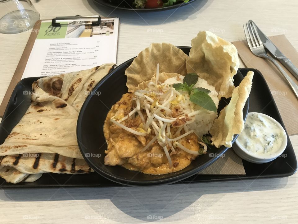 Chef’s Curry of the day -Traditional curry served with steamed basmati rice , warm rote bread, Arita and pappadams at Cheltenham RSL Melbourne Australia 