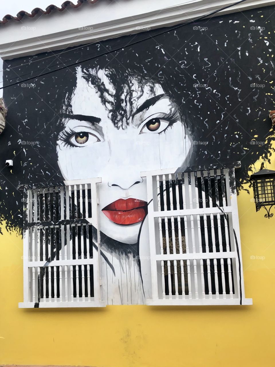 Street art - woman with black hair on yellow 