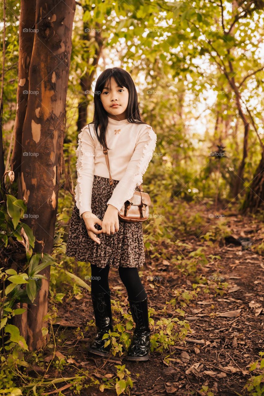 A beautiful season for some nice outdoor portraits in nature, portrait of a young little girl with fall colours.