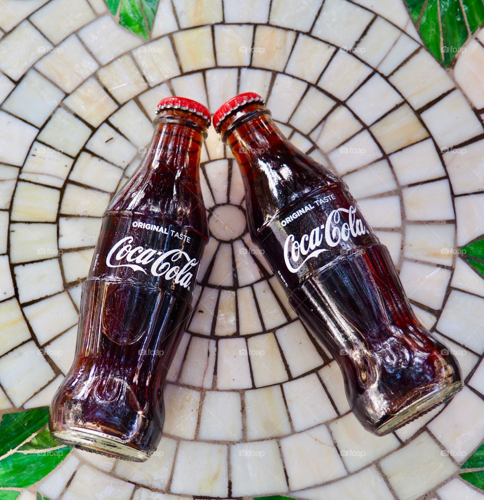 Coca Cola bottles on garden table.