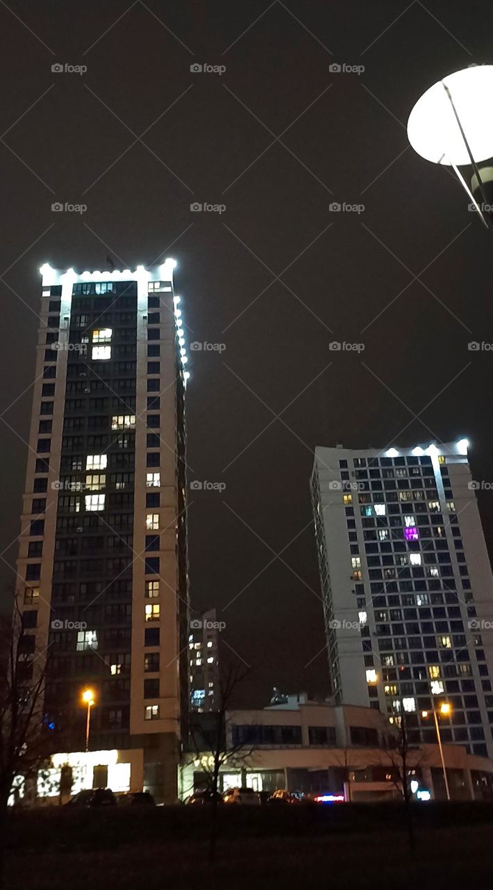 beautiful night light city windows home and reflection in water