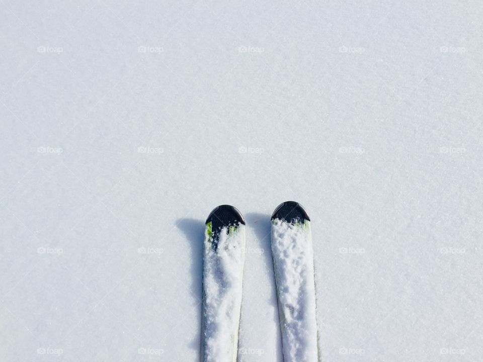 Minimalistic view of skis on fresh snow