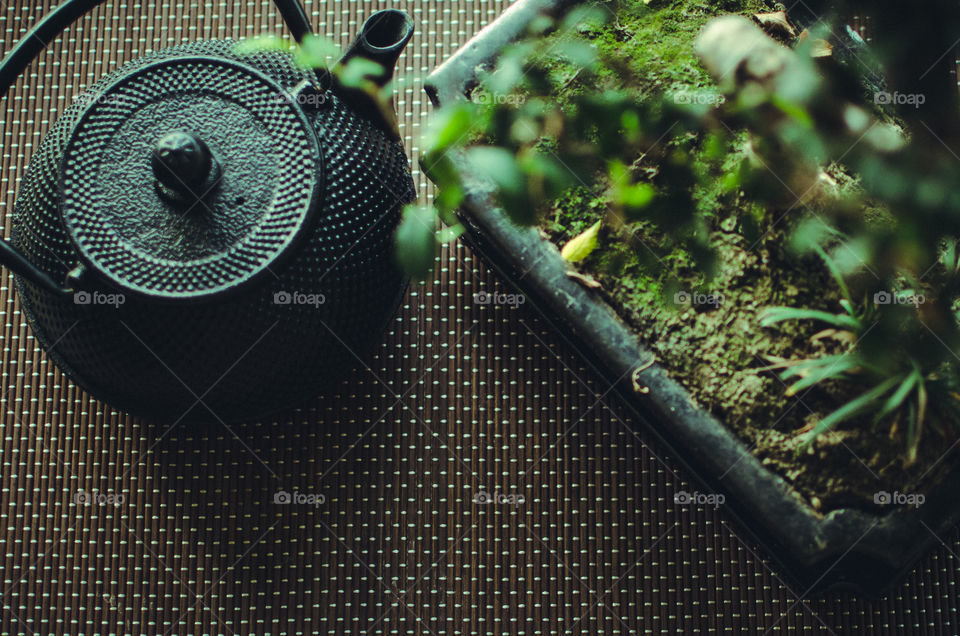 A cast iron pot of thee in a zen setting