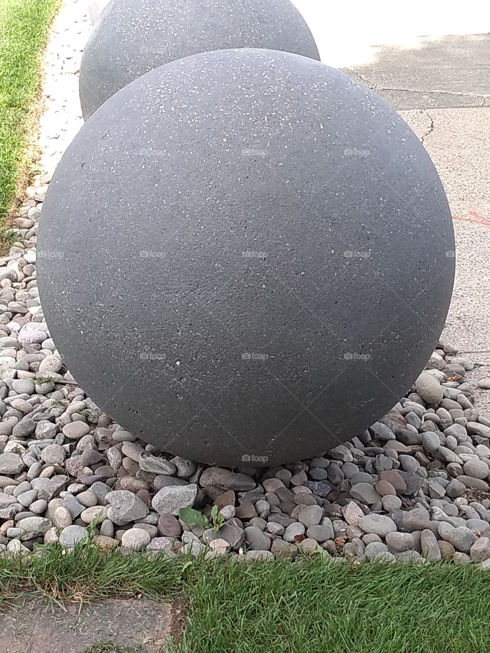 rock ball surrounded by rocks. balanced.