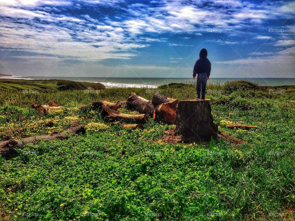 Boy standing near the sea