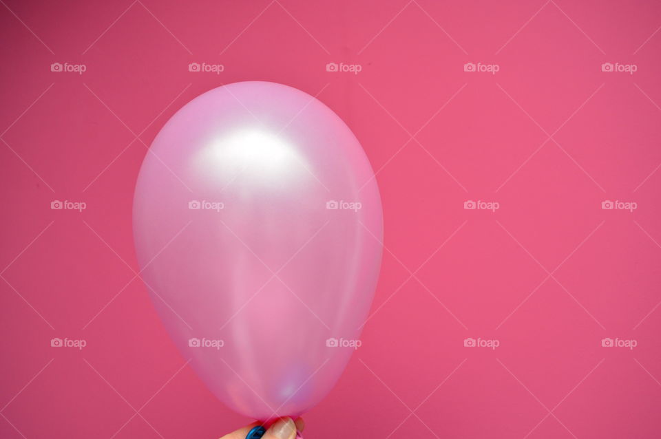 Close-up of pink balloon against pink background