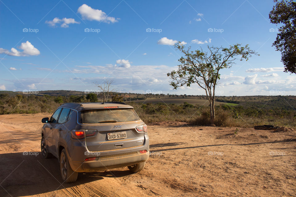 Jeep traveling on dirt road