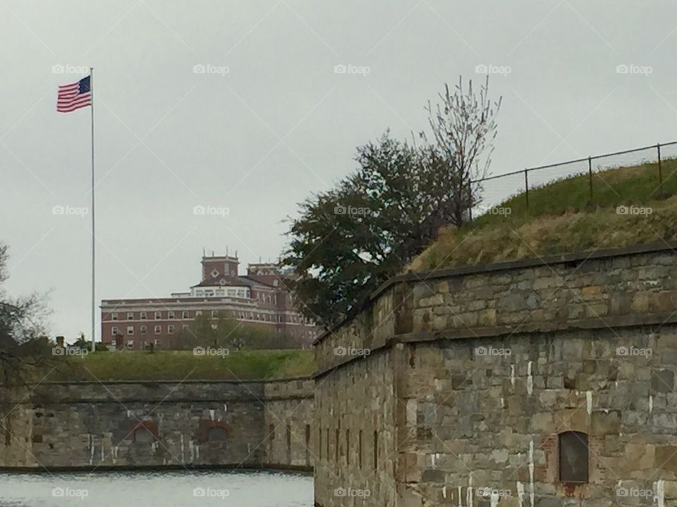Fort Monroe. Fort Monroe moat with the Chamberlin Hotel and American flag