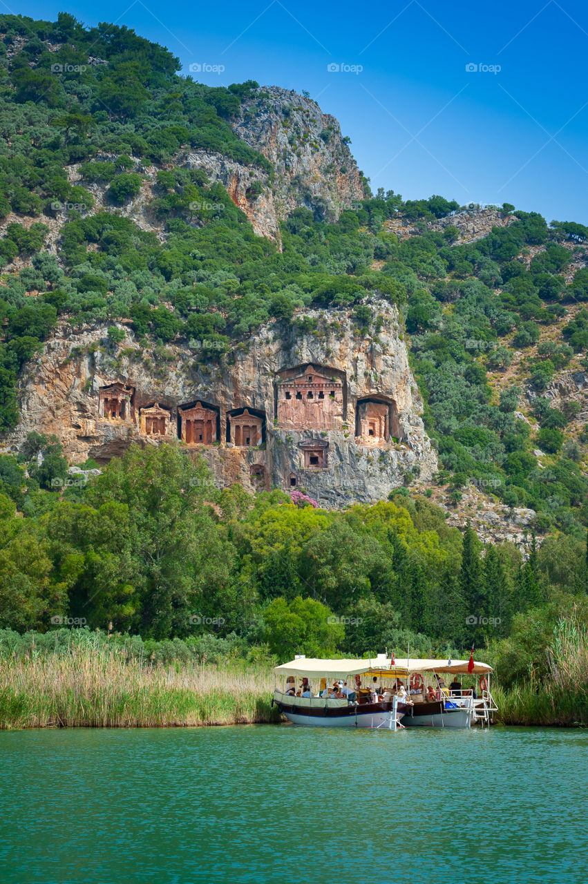 View at Kaunos, Caunos Tombs of the Kings from Dalyan Bogazi River. Turkey. The higher your grave is, the close you are to God.