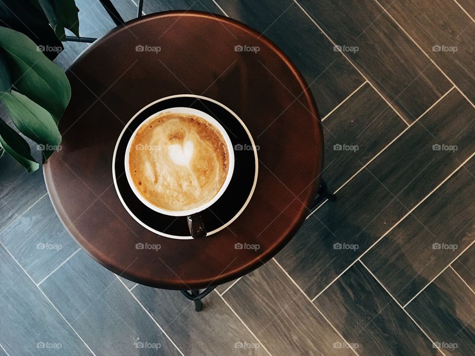 Cup of coffee on the wooden chair 