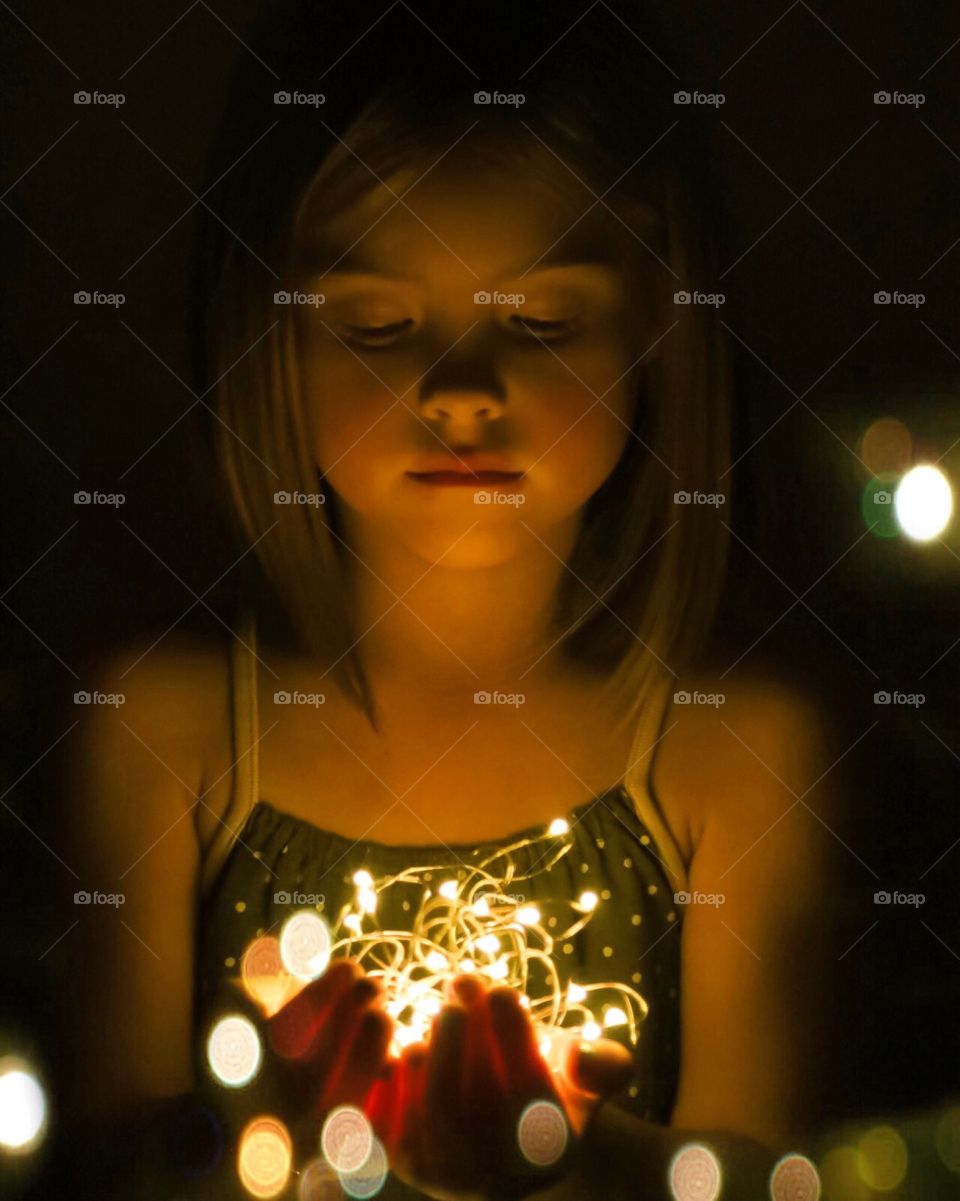 Close-up of a girl holding illuminated lights