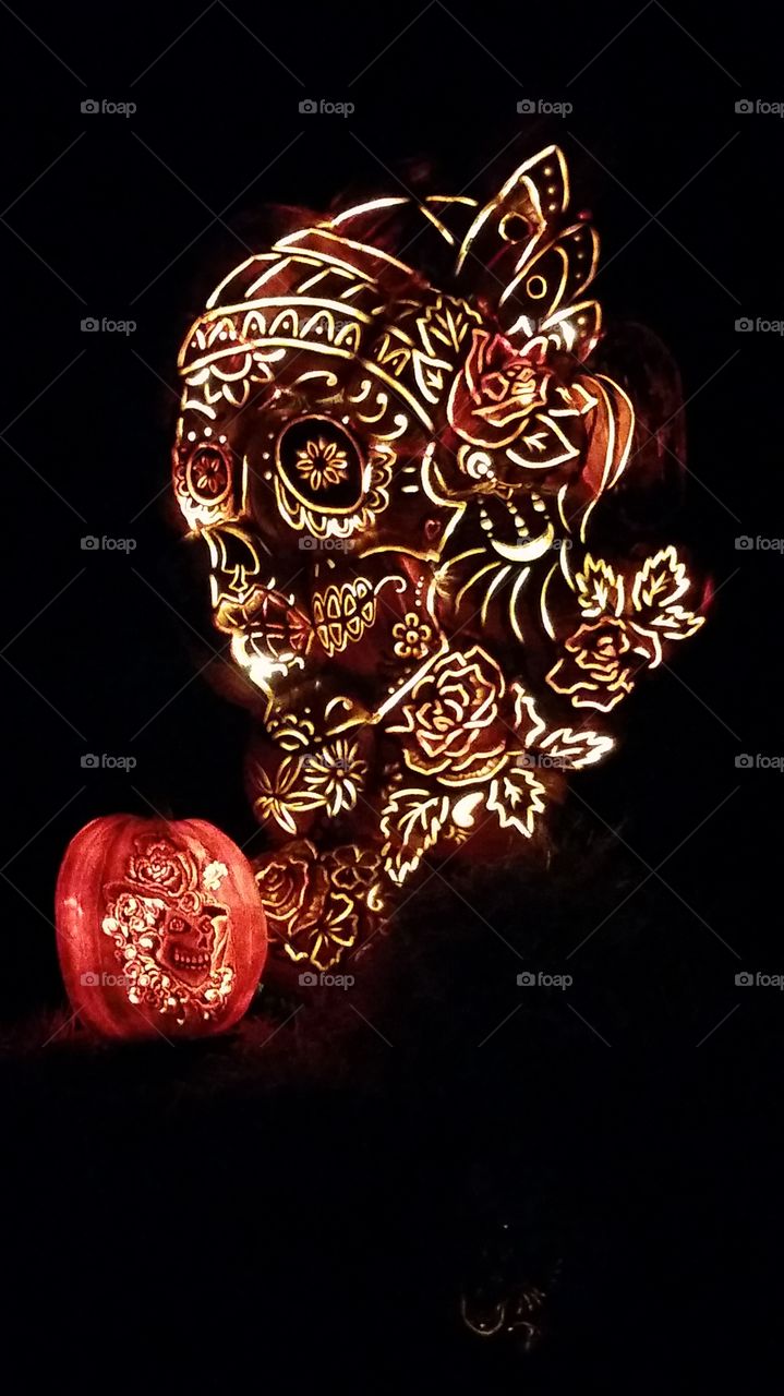 a sugar skull sculpture made of pumpkins