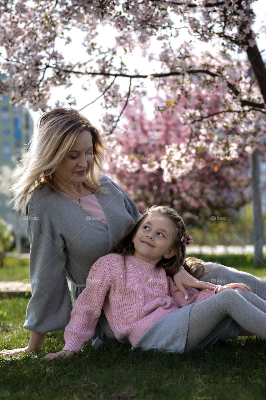 Beautiful woman and child on the picnic in the park 