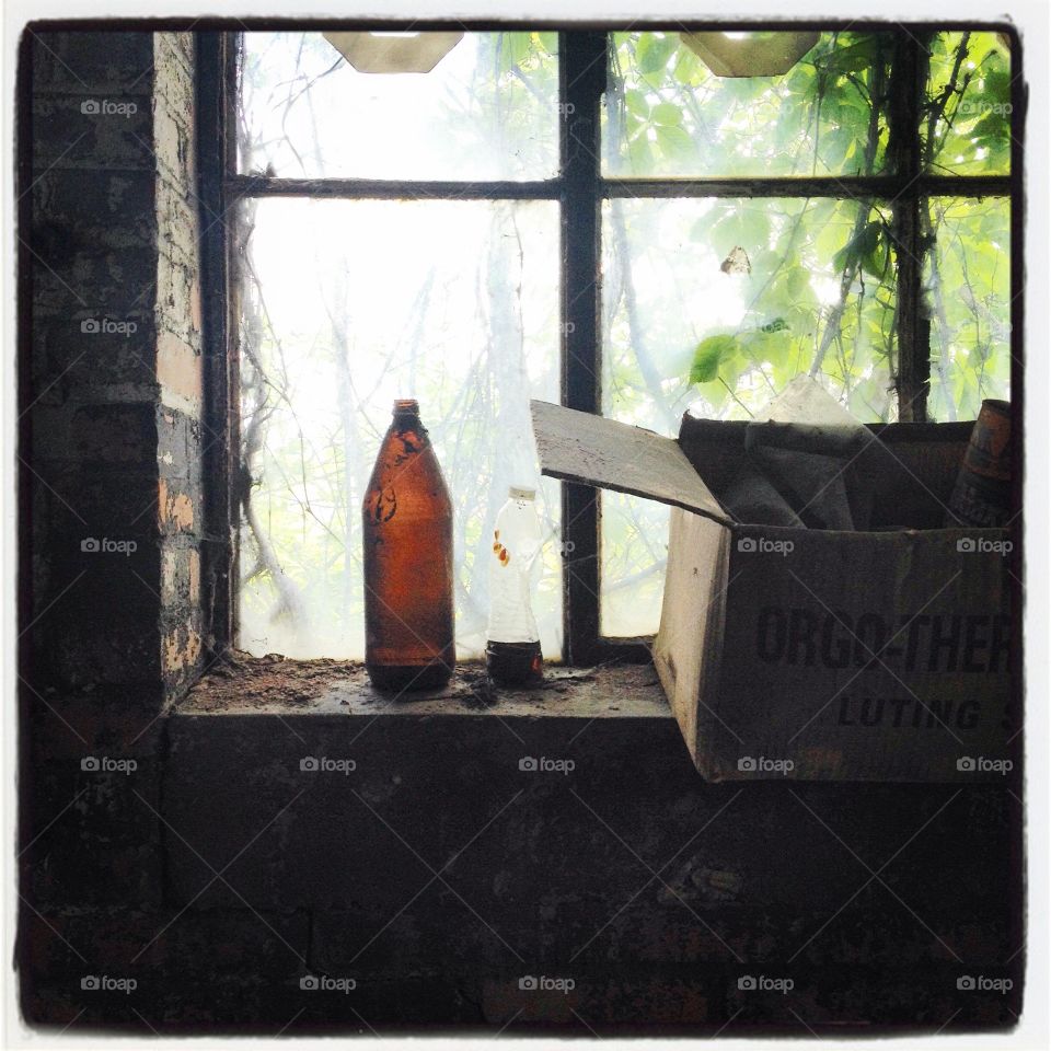 Abandoned building, bottle in window 