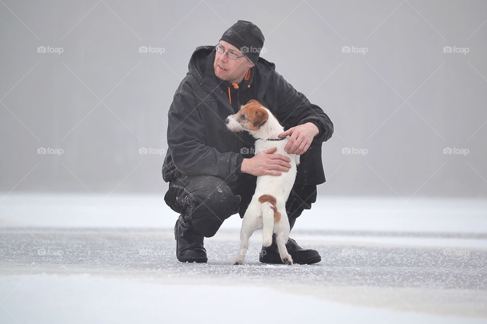 Man with his pet dog in winter