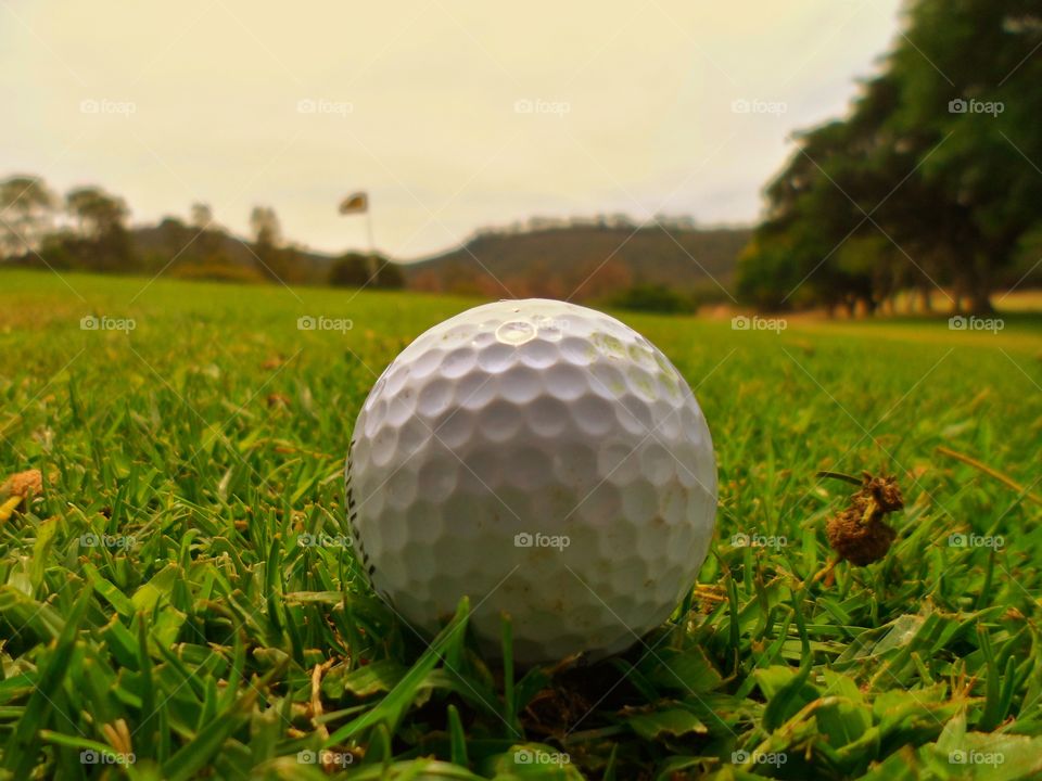 Golf ball lined up to the flag