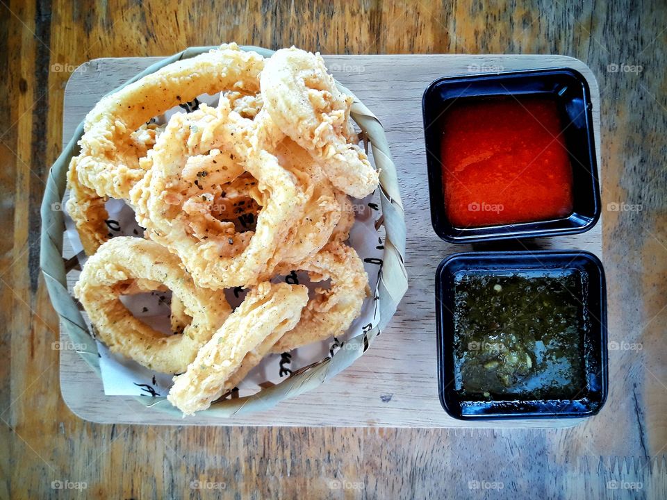 Deep-fried squid, full plate, appetizing  There are seafood dipping sauce and chili paste sauce to choose from.  All three were served on the table ready to eat.