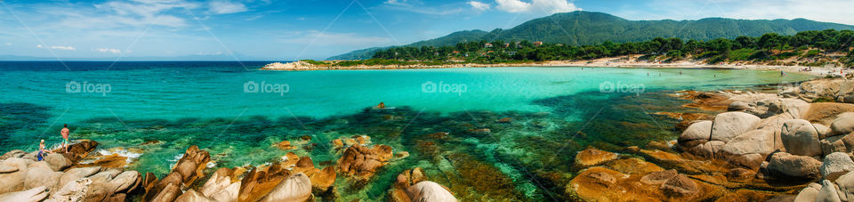 Panoramic view of Karidi Beach with rocks and cliffs in Vourvourou, Halkidiki, Greece