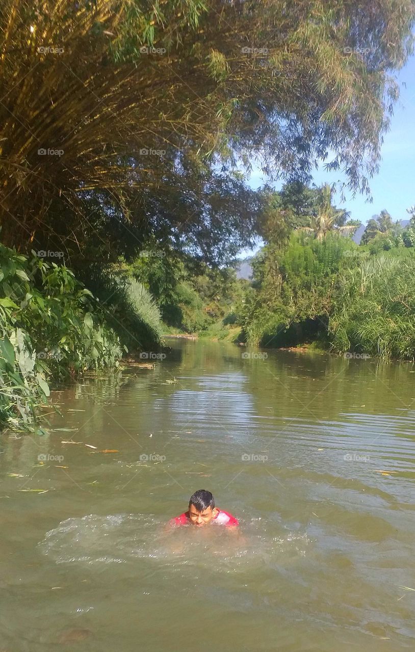 Child playing in river