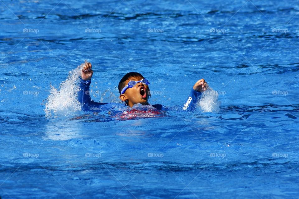 young boy learning how to swim