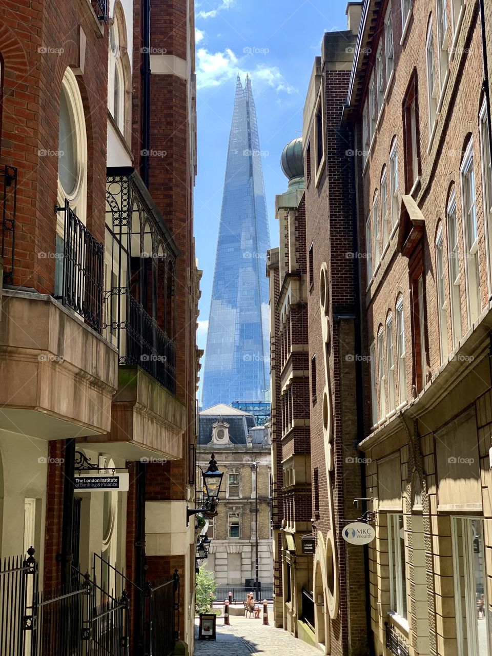 the Shard, iconic famous pyramidal skyscraper seen through residential buildings in London 