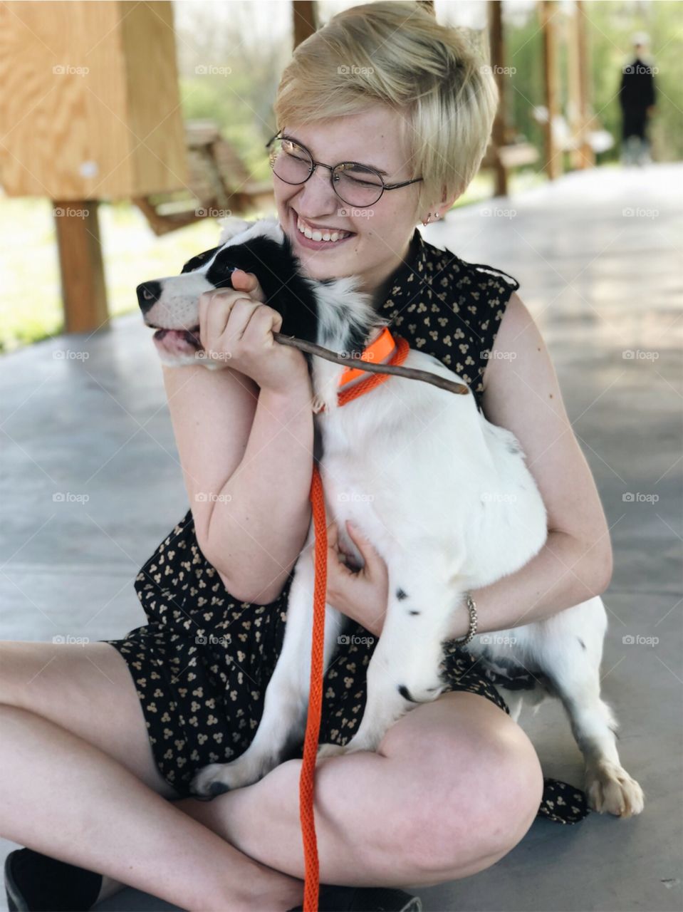 Happy Pixie Cut Girl with Puppy Playing with Stick