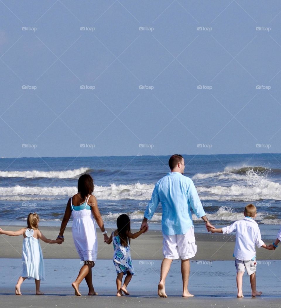 Family at the beach wearing baby blue