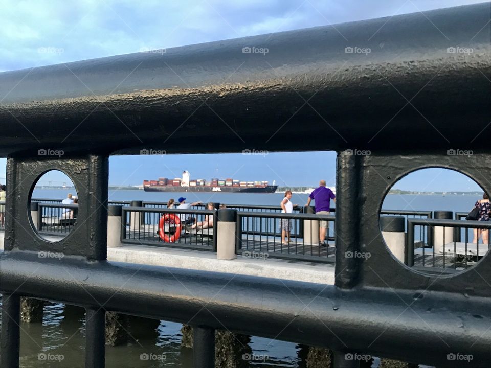 View thru the handrail of a container ship while waking along the Waterfront 