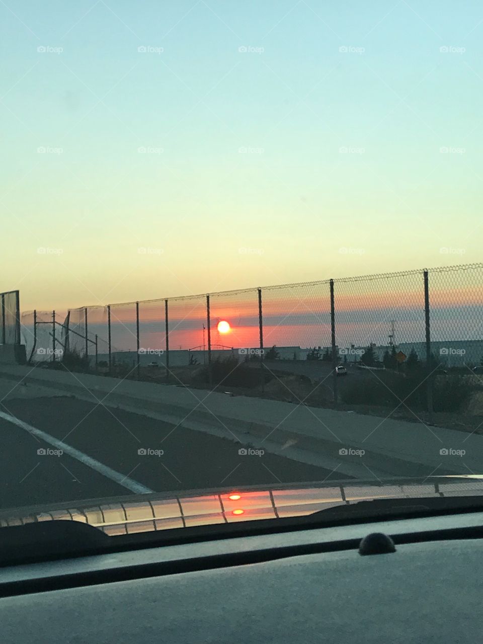 Gorgeous,radiant sunset while driving on a hot summers night 