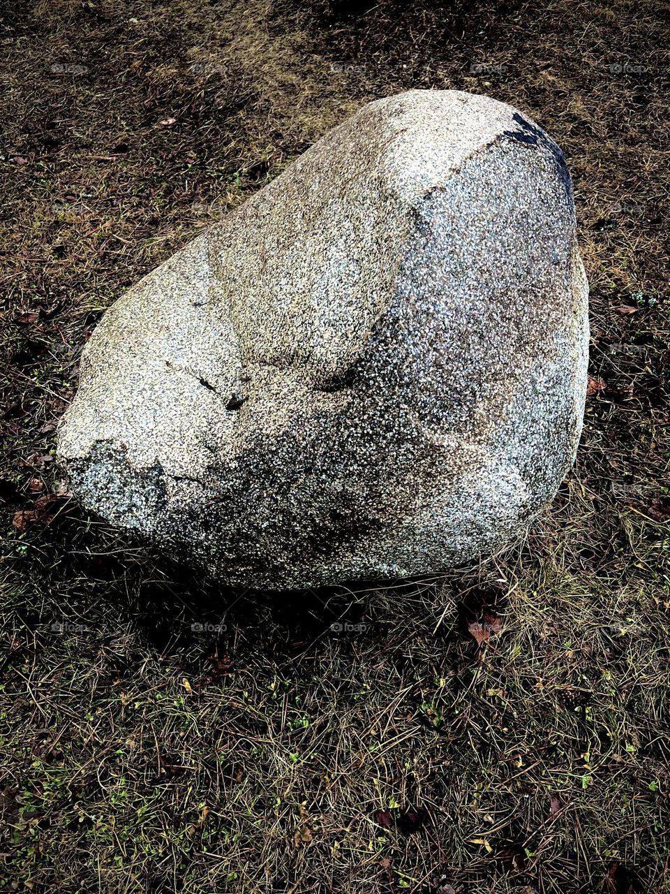 A large boulder shaped like a seat, with bands of color.