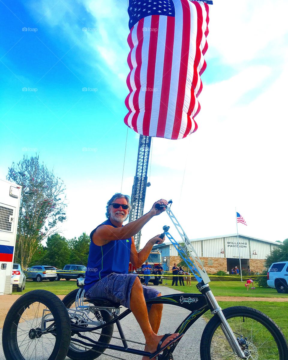 Father in law cruising my trike at the 4th of July festival 
