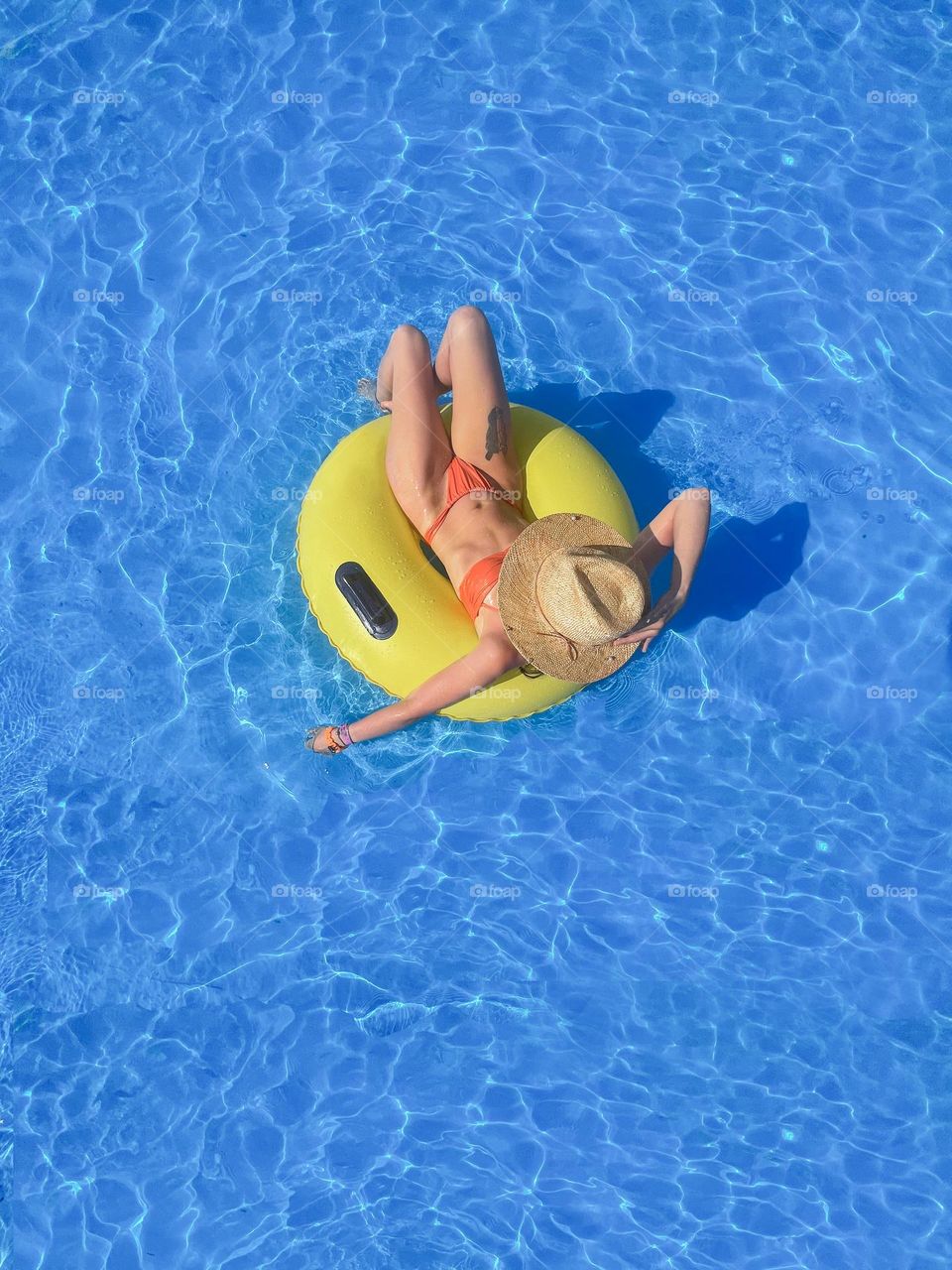 girl swims in the pool on an inflatable ring