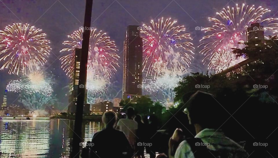Loud crackling noises in the sky over “Newtown Creek” let everyone know that the annual “July 4th” “Independence Day” “Macy’s fireworks” have begun. This year’s launch comes from several boats on the “East River” nearby. 2022. Hypnotic Productions
