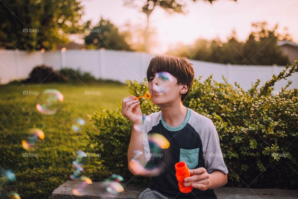 Boy blowing bubbles 