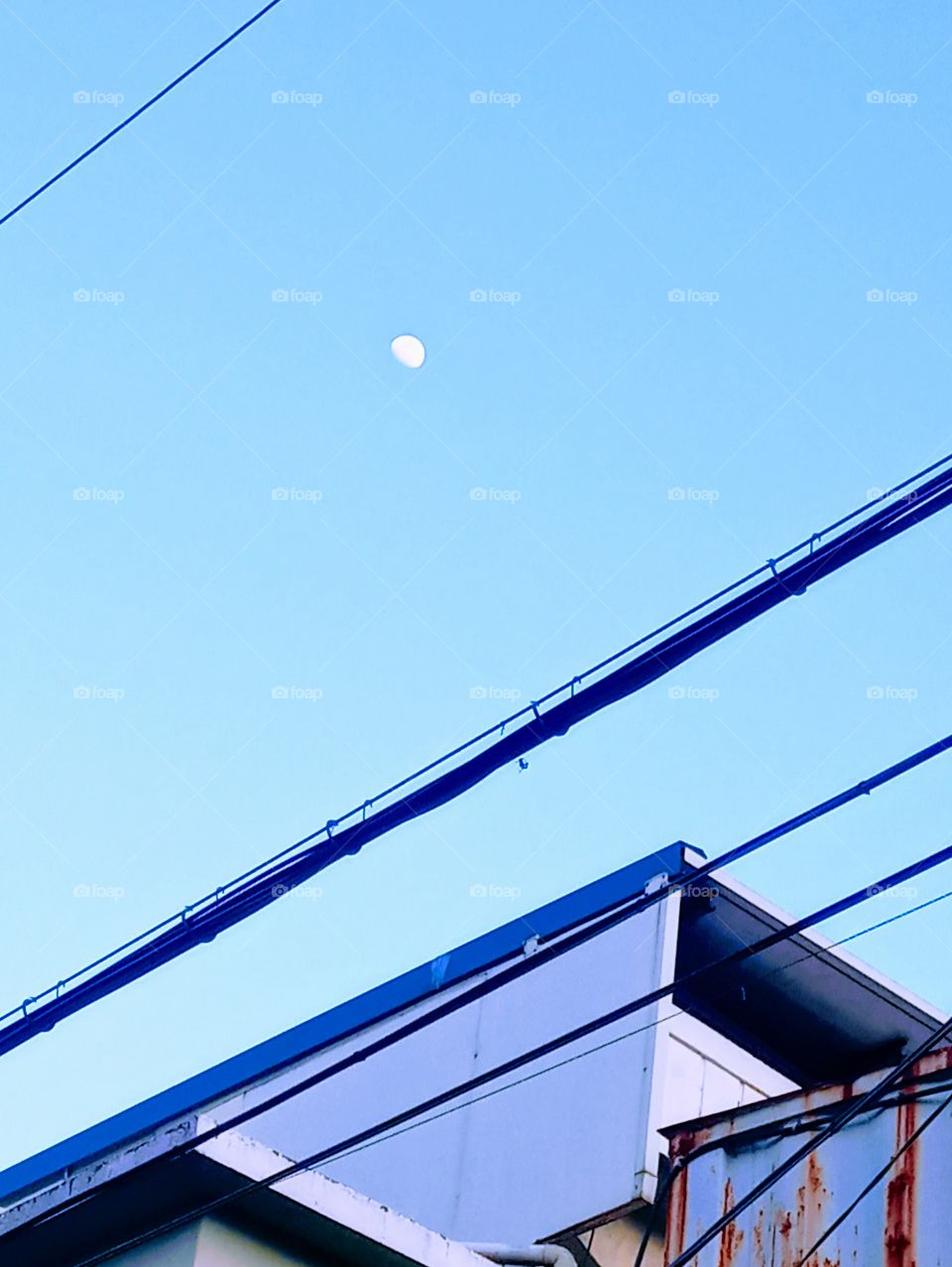 The Moon that shine so early in the clear blue skies before the darkness of the night comes.