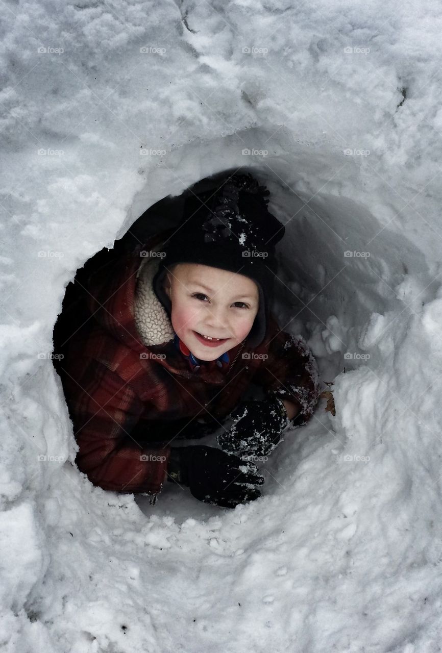 Boy in snow cave