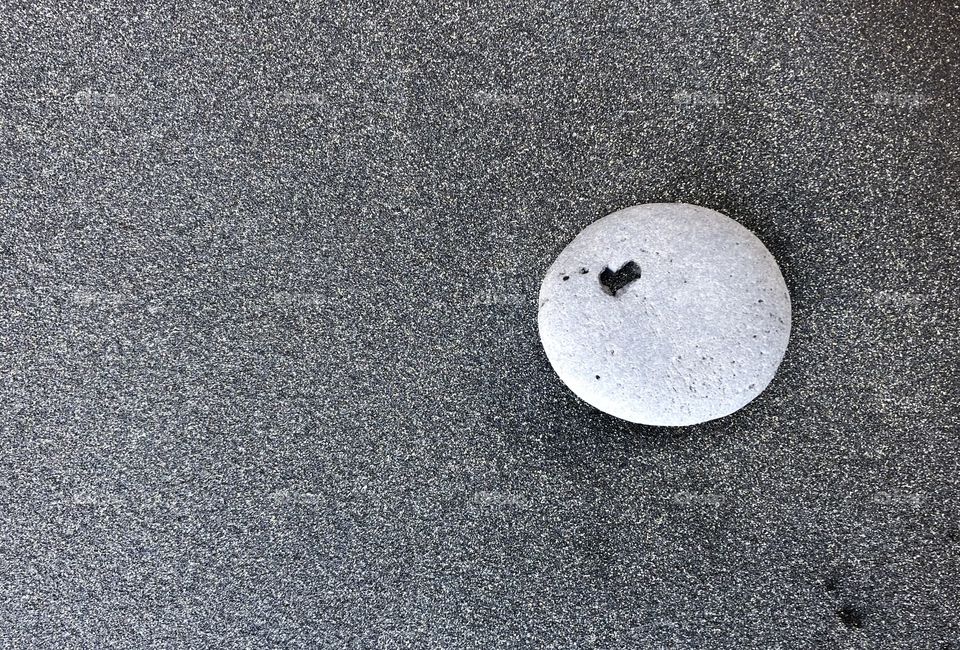 heart in stone on a black sand beach