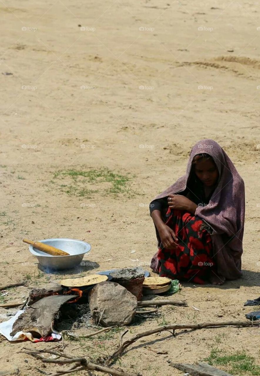 pic one and the the two different versions. .of life..the first one is a woman cooking food on an open field.she doesn't have a shelter to stay.she is a tribal woman, her husband died several years ago because of tuberculosis.color of poverty