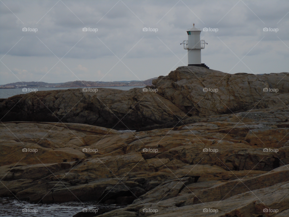 sea cloudy rocks lighthouse by MagnusPm