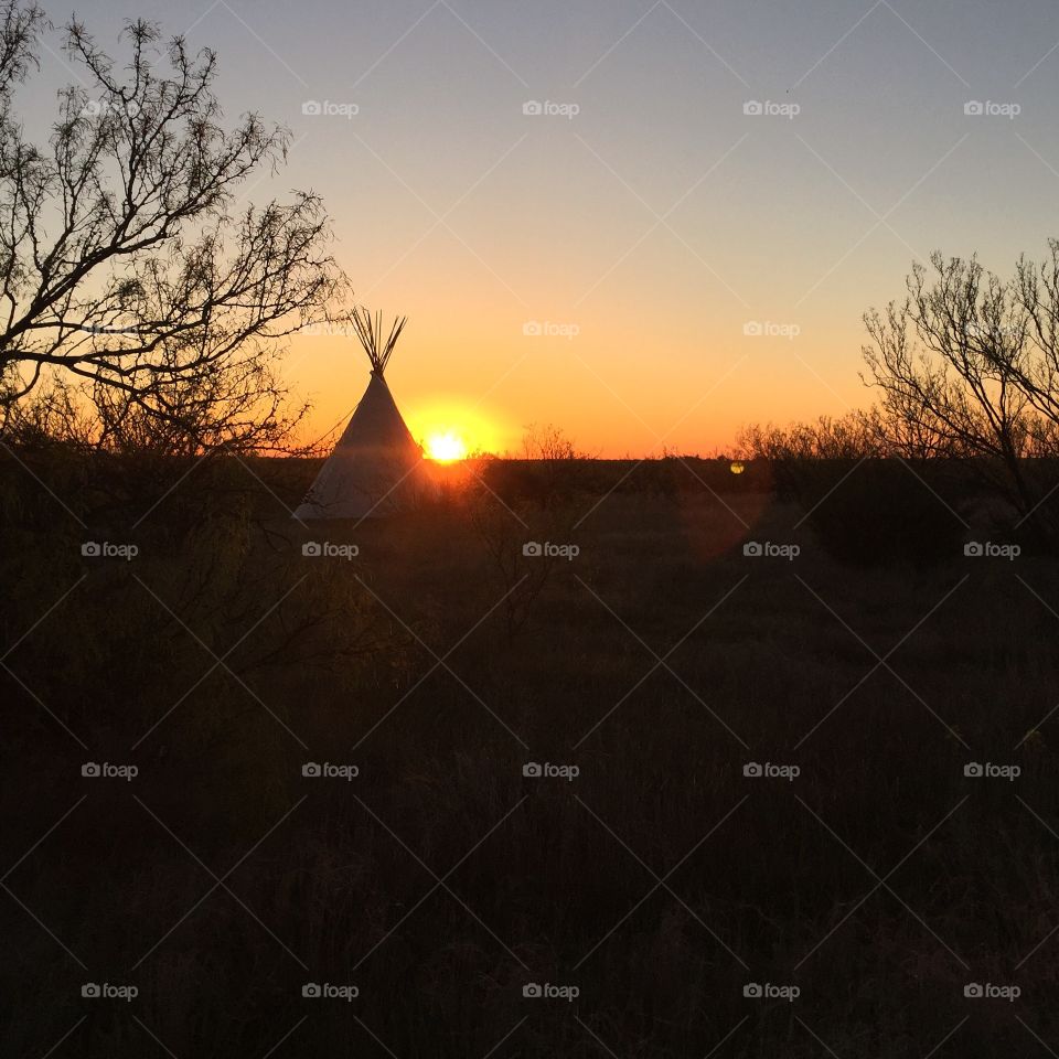 Sunrise over the Texas Panhandle, with a tee pee caught in the light 