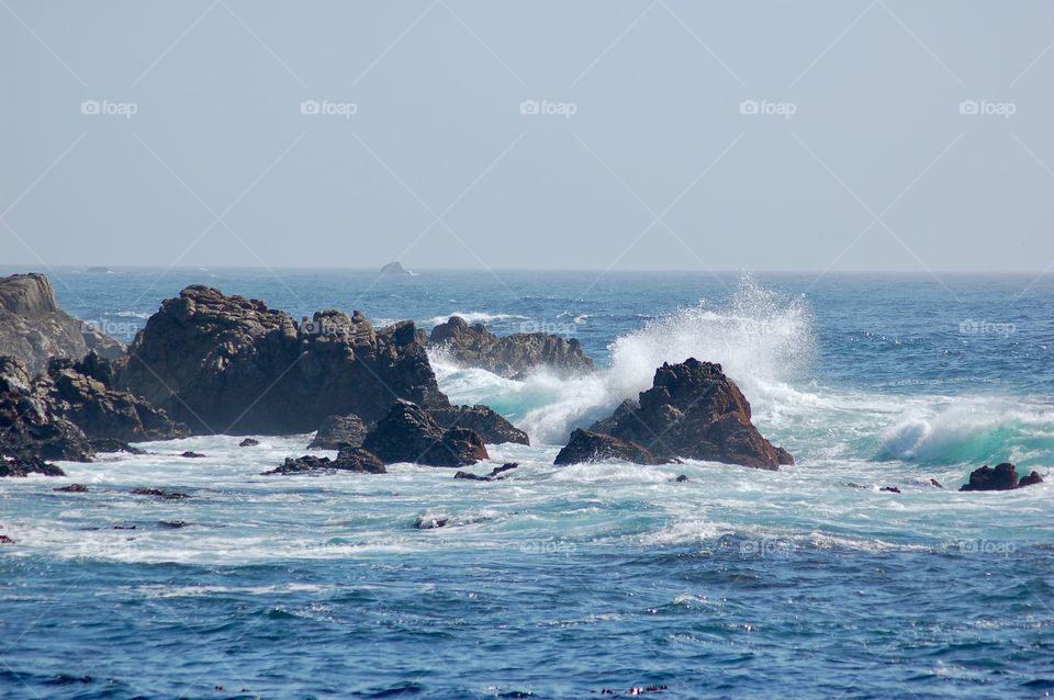 Surf Breaking On Rocks