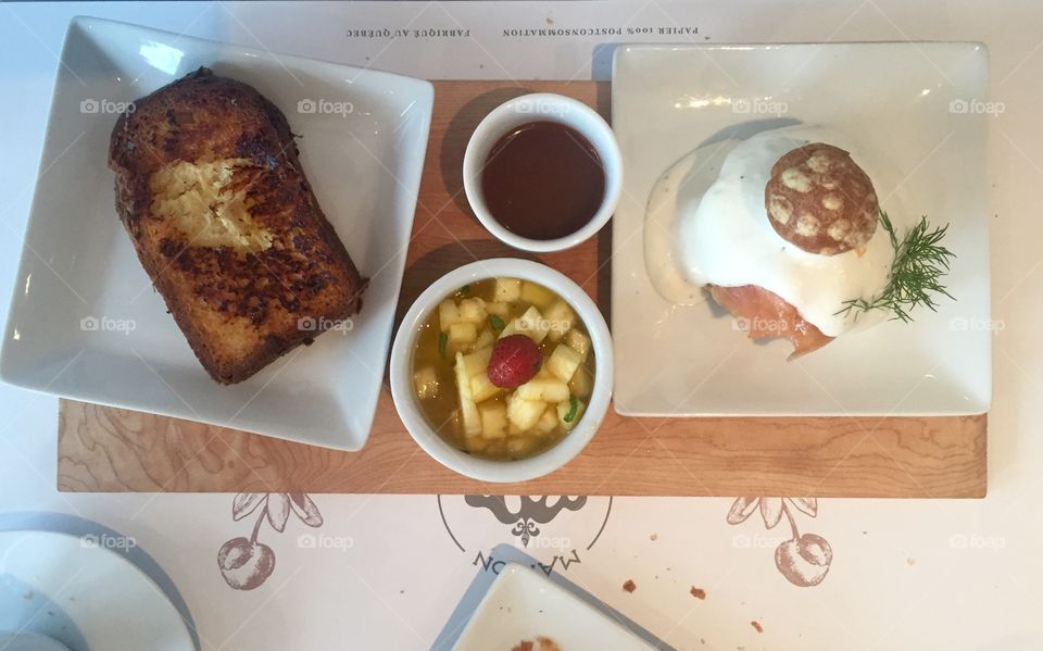 Salmon eggs Benedict, French toast and pineapple salad brunch 