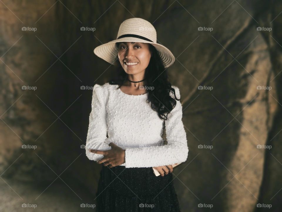 Portrait of a woman against rock background 