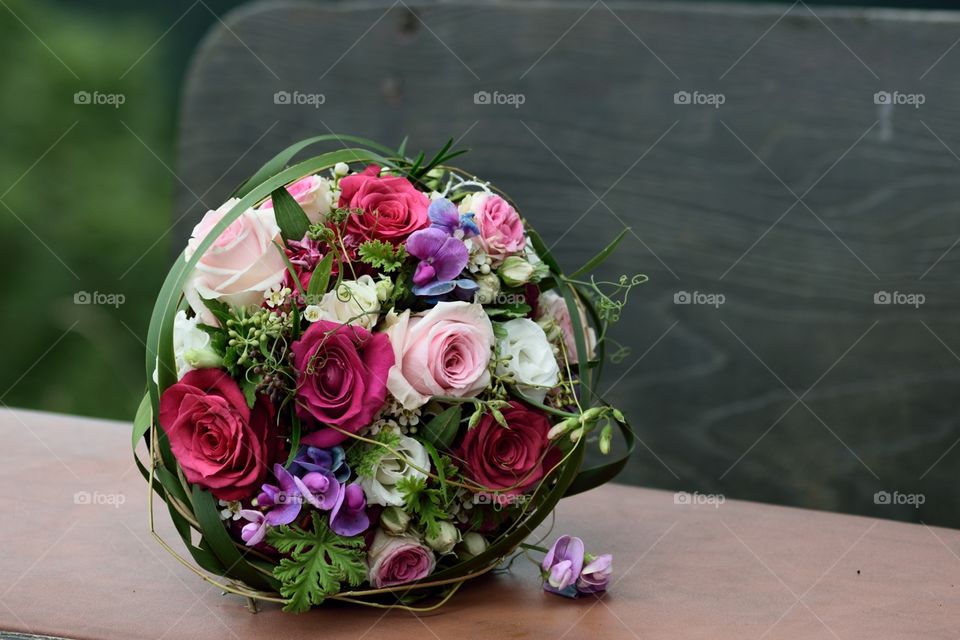 Wedding bouquet with roses and green on a table.