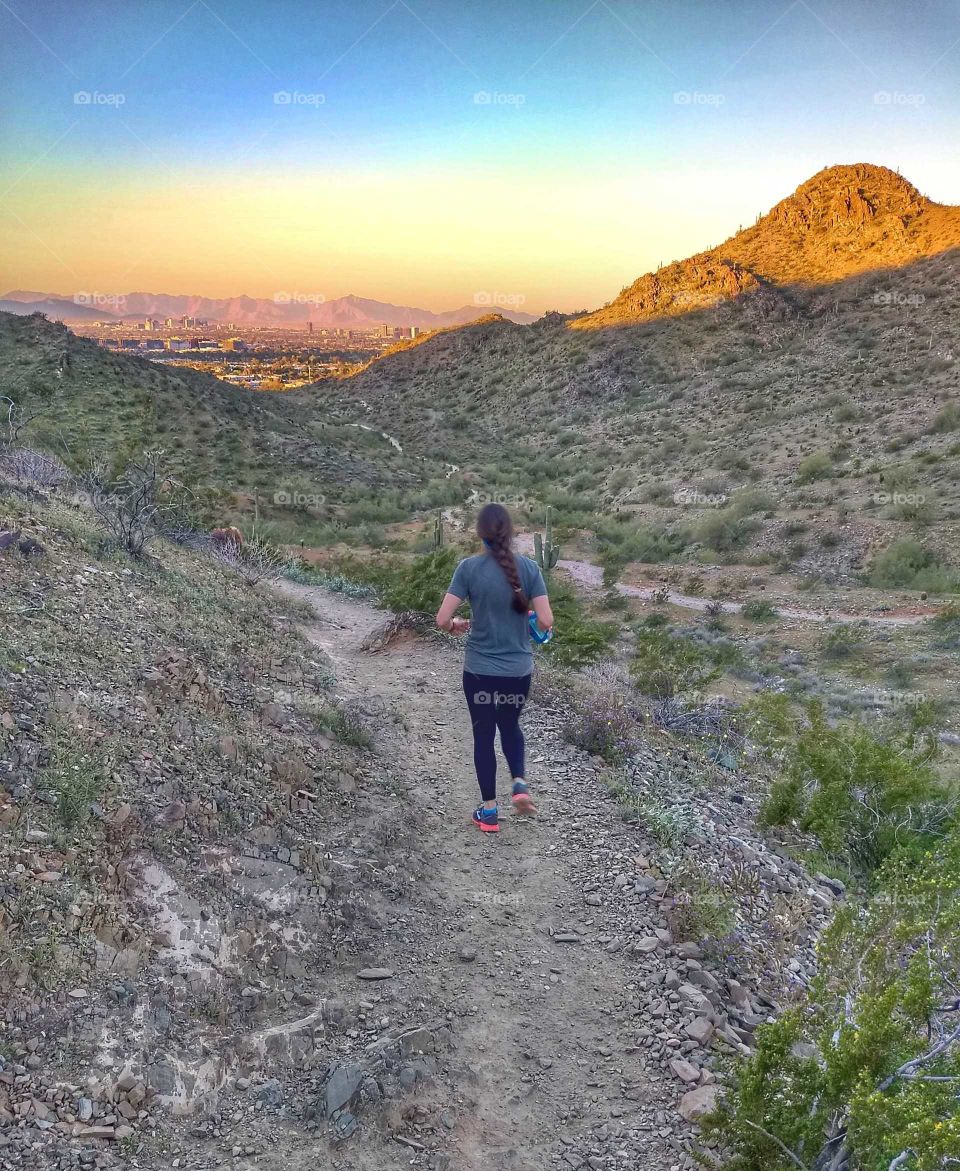 woman runs on a Desert Mountain Trail